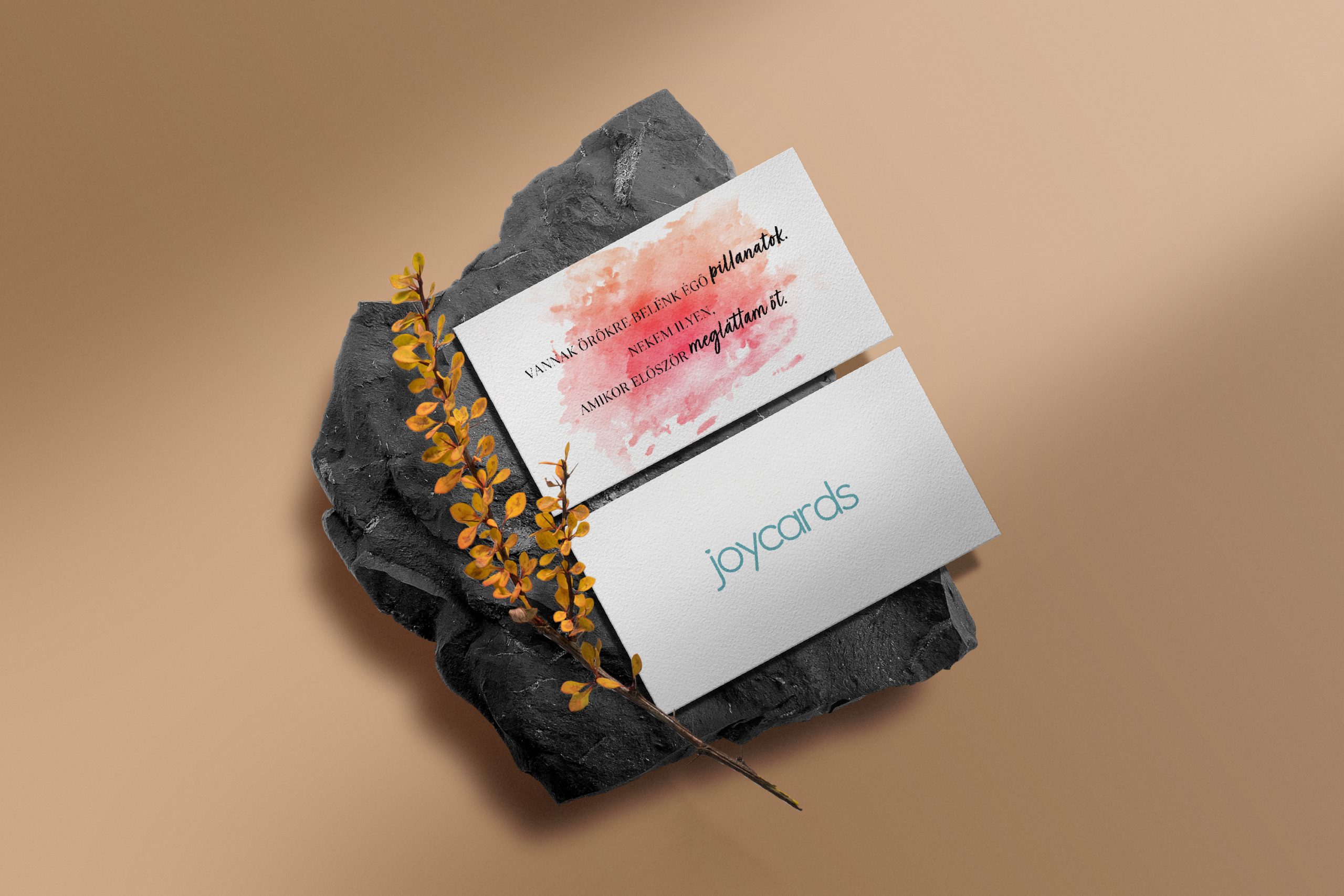 Clean minimal business card mockup on black stone with yellow pl